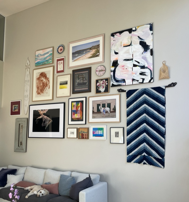 Eclectic salon-style gallery wall in living room