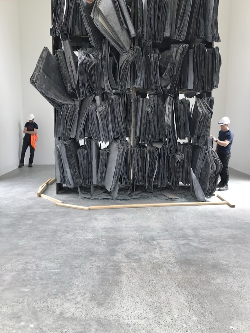 Monumental sculpture installation with workers