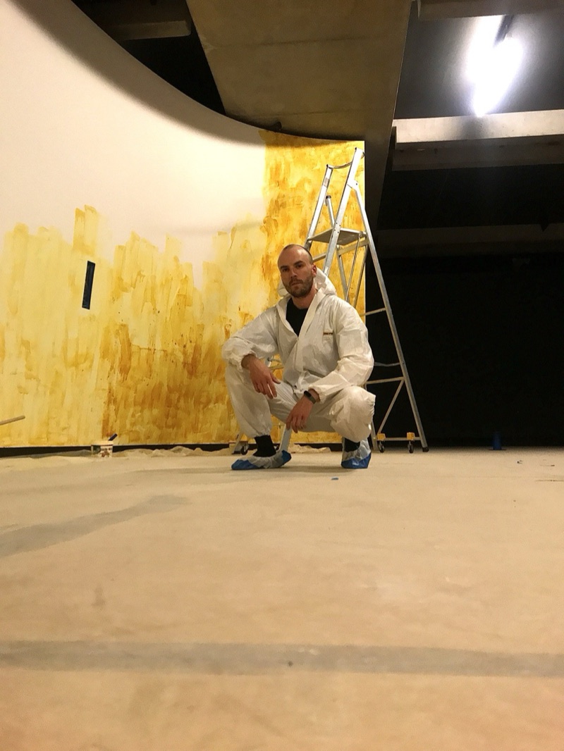 Worker preparing gold gallery walls