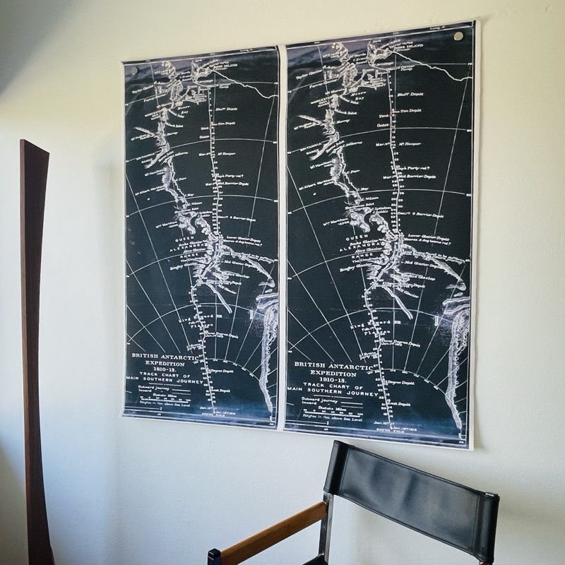 Pair of British Antarctic Expedition track charts hung on a white wall